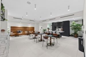 a restaurant with tables and chairs in a room at Chic Luxury 1BR Oasis in Miami