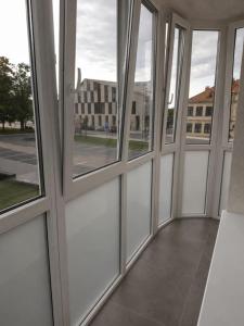 an empty room with windows in a building at Town Square Apartment in Panevėžys +3 photos