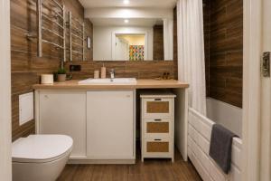 a bathroom with a toilet and a sink at Town Square Apartment in Panevėžys