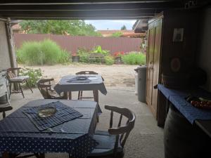 a patio with a table and a table and chairs at Kék Vándor Vendégház in Rédics