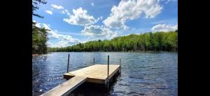 a dock in the middle of a lake at Le Béluga in Saint-Calixte