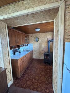a small kitchen with a sink and a stove at Boravak Tarhaniš Rožaje in Rožaje +31 photos