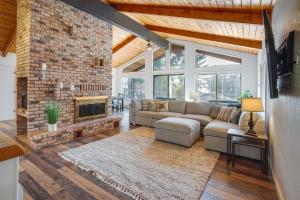 a living room with a couch and a fireplace at Tree-Lined Gold Beach Retreat w/ Multiple Decks! in Gold Beach