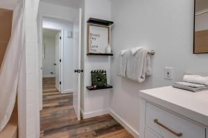 a bathroom with white walls and a white counter top at Tree-Lined Gold Beach Retreat w/ Multiple Decks! in Gold Beach +19 photos