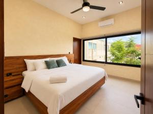 a bedroom with a large bed and a large window at Itza Living Apartments in Flores