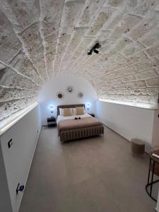a bedroom with a bed with a stone ceiling at Buonaventura house2 in Triggiano