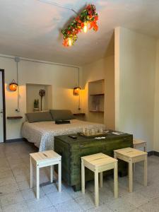 a bedroom with a bed with two tables and two stools at La Radura in Roccamorice