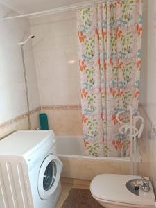 a bathroom with a washing machine and a toilet at La Casa de Lines in Monforte de Lemos +18 photos