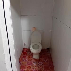 a small bathroom with a toilet in a stall at PELLY Homestay Explorer in Vunivuthea +27 photos