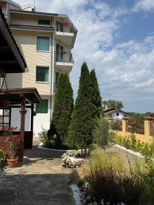 a building with two trees in front of it at Семеен хотел САМИ in Kranevo