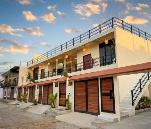 a building with wooden doors and a balcony at Itza Living Apartments in Flores