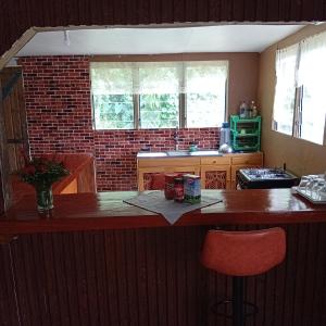 a kitchen with a wooden counter and a red chair at PELLY Homestay Explorer in Vunivuthea