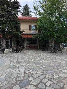 a building with tables and benches in a courtyard at FANTINO HOTEL in Domnista +47 photos