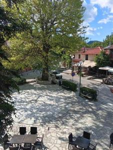 a park with benches and a tree on a street at FANTINO HOTEL in Domnista