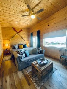 a living room with a couch and a wooden ceiling at Ye Olde Argyler Lodge in Pubnico
