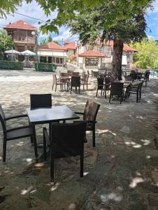 a group of tables and chairs in a courtyard at FANTINO HOTEL in Domnista