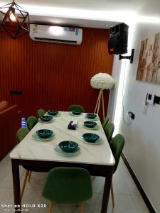a table with green chairs in a room at BELLA ViTA in Jeddah