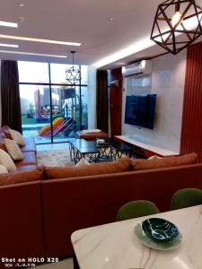 a living room with a couch and a tv at BELLA ViTA in Jeddah