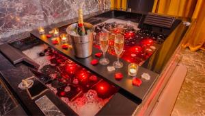 a table with wine glasses and candles on it at L'Écrin d'Or - Spa - Cinéma privé in Saumur