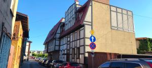 a building with cars parked on the side of a street at Apartament Sobieskiego in Puck