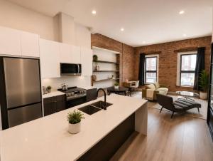 a kitchen with a counter top and a living room at The Post Hotel in Renfrew