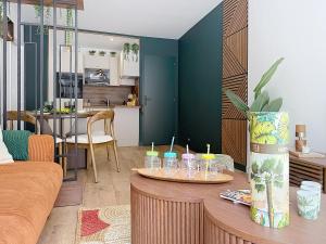 a living room with a table with candles on it at L'Amour des Îles - Centre - Plage - Parking in Cabourg