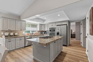 a kitchen with white cabinets and granite counter tops at Riverside Harbor House in Post Falls ID in Post Falls