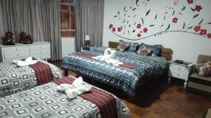 a bedroom with two beds with white towels on them at Don Andre House in Cusco