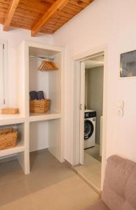 a room with a door leading into a kitchen with a stove at Omnia Apartments Amorgos No2 in Amorgos