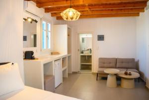 a room with a bed and a couch and a table at Omnia Apartments Amorgos No2 in Amorgos