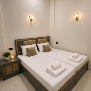 a bed with two pillows on it in a room at Sunrise View K8 Apartments in Hurghada