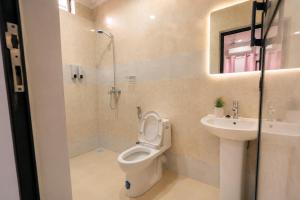a bathroom with a toilet and a sink at Cozy Quarters in Zanzibar City +27 photos