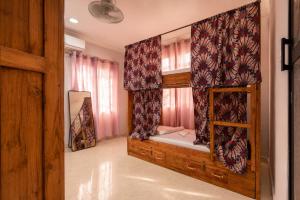 a room with a bunk bed with a window at Cozy Quarters in Zanzibar City