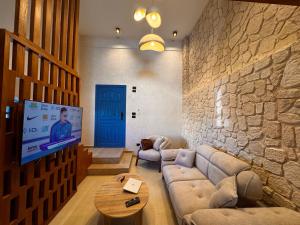 a living room with a couch and a tv at Naama Lofts in Sharm El Sheikh