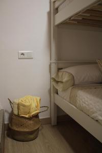 a bedroom with a bunk bed and a basket at La Divina 1 in Ribadavia