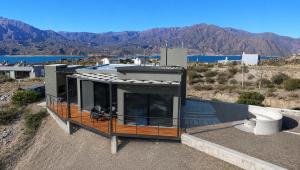 a house on a hill with mountains in the background at Villamagna, cabaña con jacuzzi en Potrerillos in Potrerillos