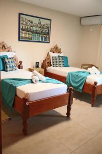 two beds sitting in a room at Résidence Simona Premium in Deshaies +24 photos