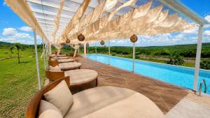 a resort with a swimming pool with chairs and a pool at El campanario Glamping in Jalcomulco +3 photos