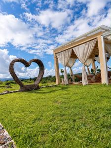 a sculpture of a heart in the grass at El campanario Glamping in Jalcomulco