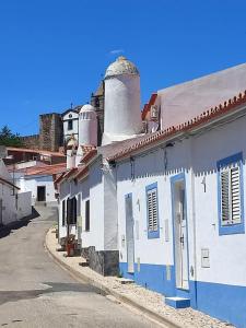 a row of white and blue buildings with towers at Akonxego&Cia in Mourão
