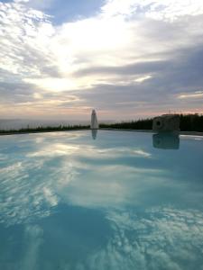 a pool of blue water with a boat in the background at Paco d'Anha in Viana do Castelo