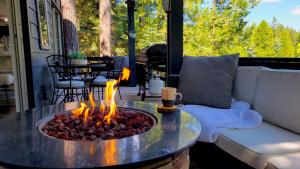 a fire pit in the middle of a table on a porch at Cielo Ridge in Twin Peaks