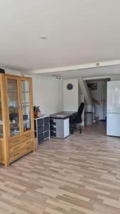 an empty room with a desk and a refrigerator at Michelle's Yellow house in Ilulissat