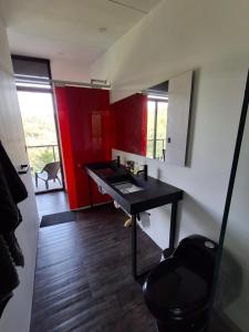 a bathroom with a black sink and a mirror at Cabaña Guane in Pacho