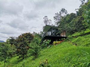 a house on the side of a hill at Cabaña Guane in Pacho
