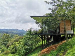a tree house on a hill with a view at Cabaña Guane in Pacho