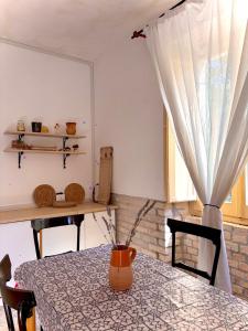 a dining room table with a vase on it at Little fox in Miglianico