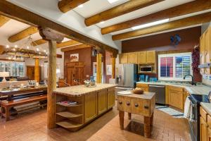 a large kitchen with wooden cabinets and a table at Cereus Vista in Tucson