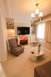 a living room with a couch chair and a fireplace at Landmark Residence - OFICIAL in São Paulo