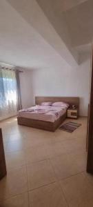 a bedroom with a bed in the corner of a room at Casa in Durrës
